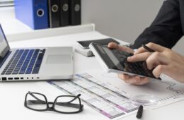 side-view-business-man-calculating-finance-numbers