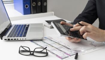 side-view-business-man-calculating-finance-numbers