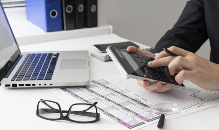 side-view-business-man-calculating-finance-numbers